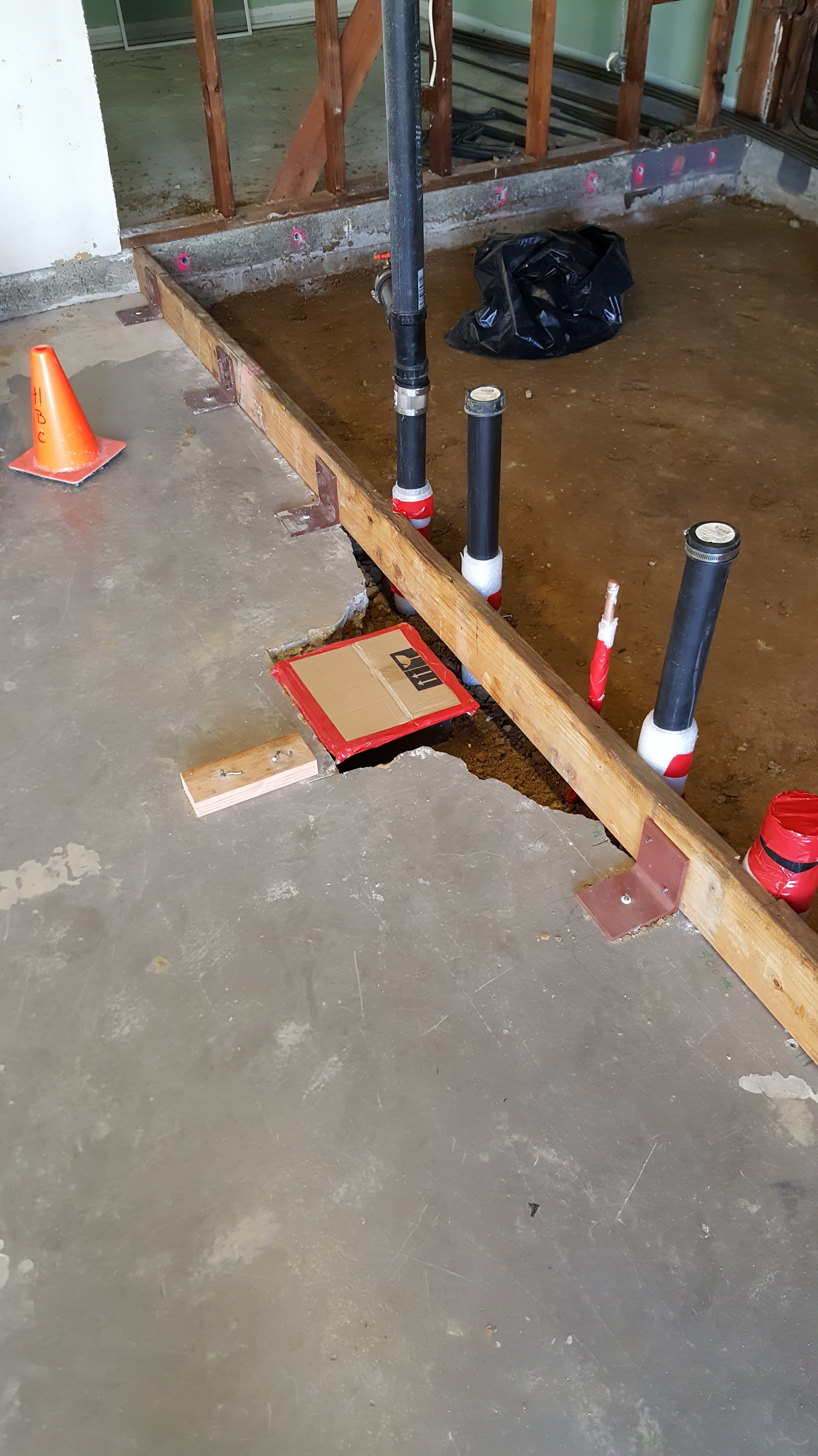Remodel underslab drains and vents with proper slope and cleanouts.