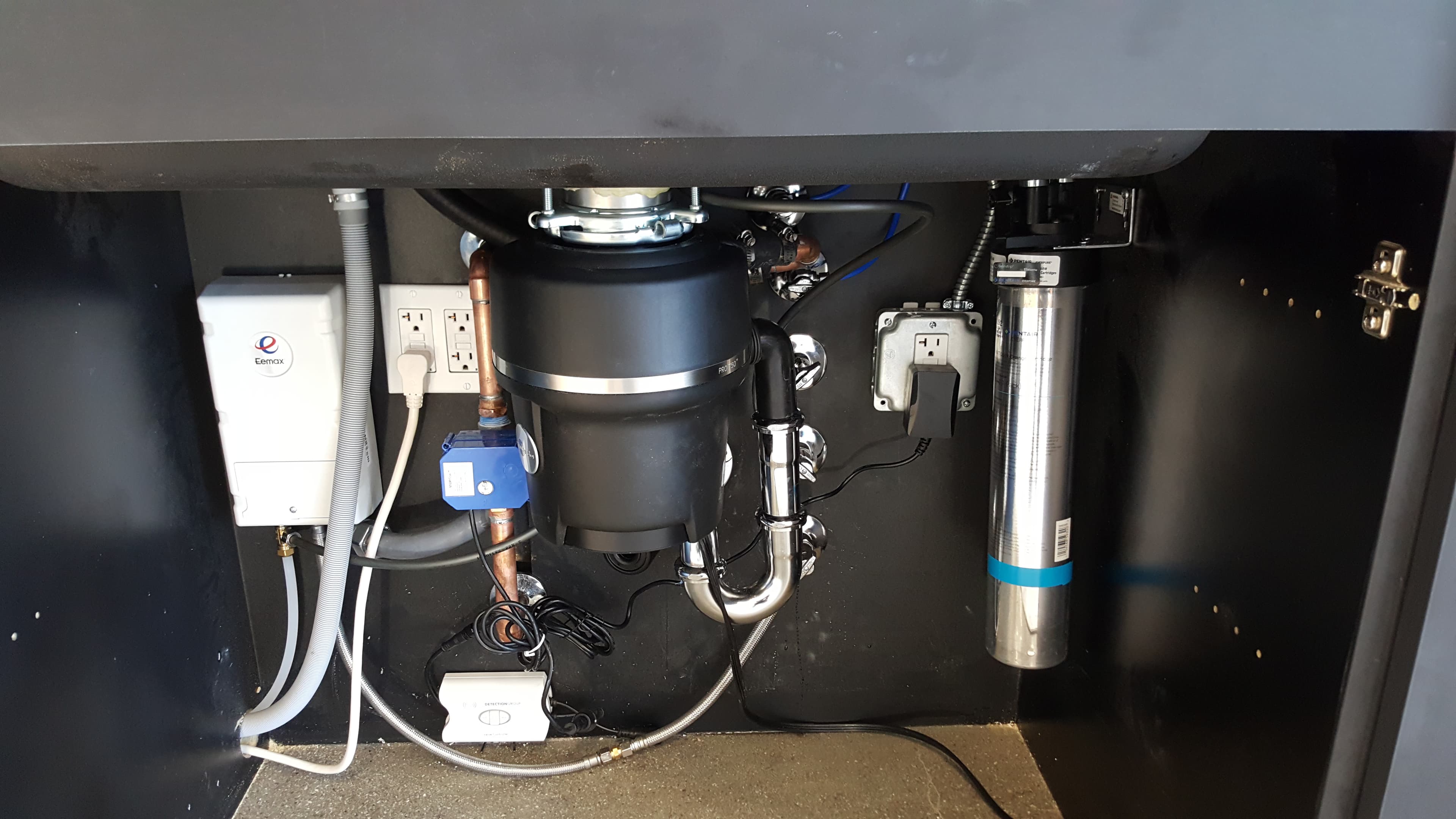 Under-sink install with Eemax tankless heater, disposal, filtration, and leak sensor.